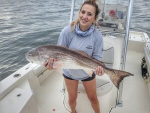 girl holding fish on charter boat